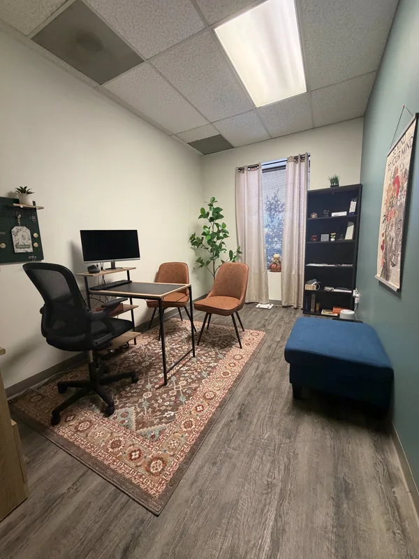 Inside the El Paso office, with guest chairs, plants, and a desk